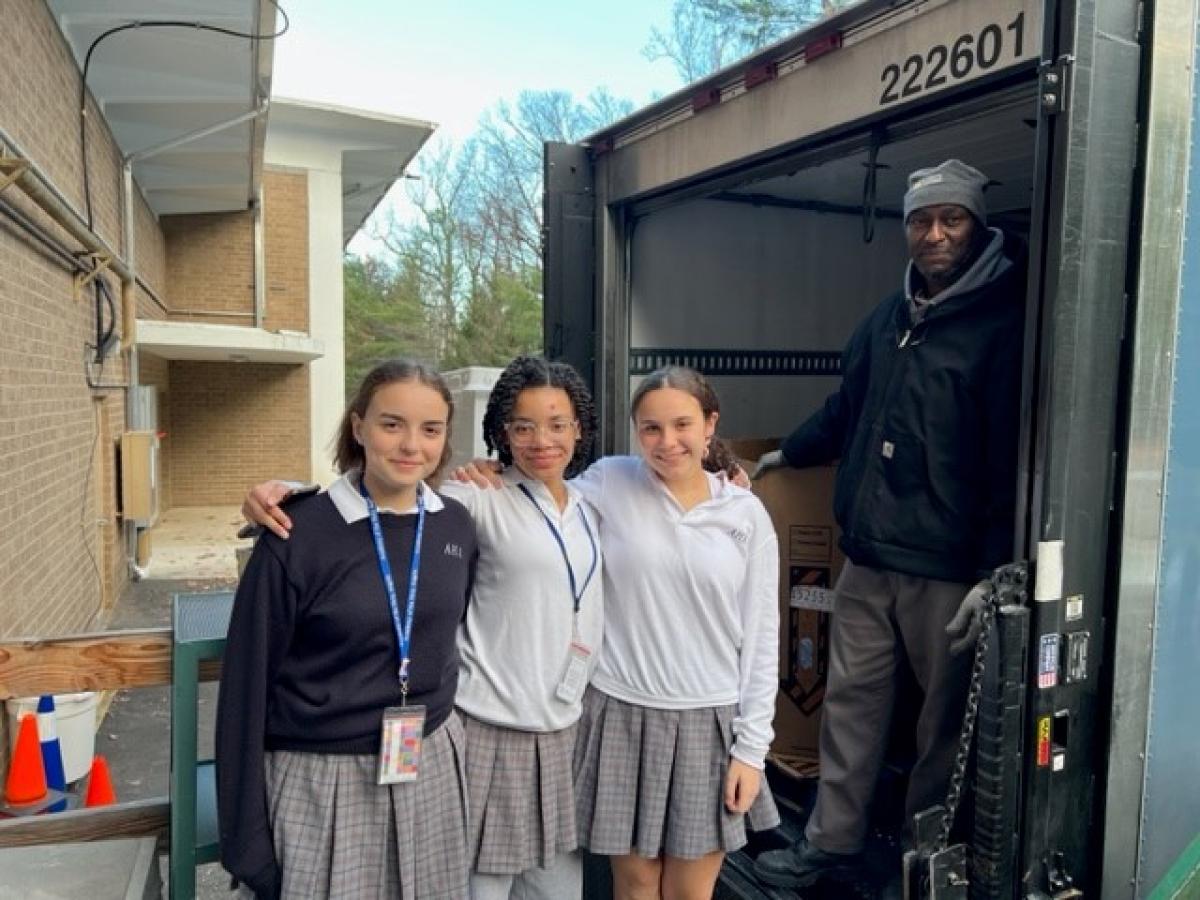 Lucia McClure of Wyckoff, Amaris Hiatt of River Vale, and Anna Daniello of Upper Saddle River brought their turkeys to Keith Owens from the Community FoodBank of New Jersey.